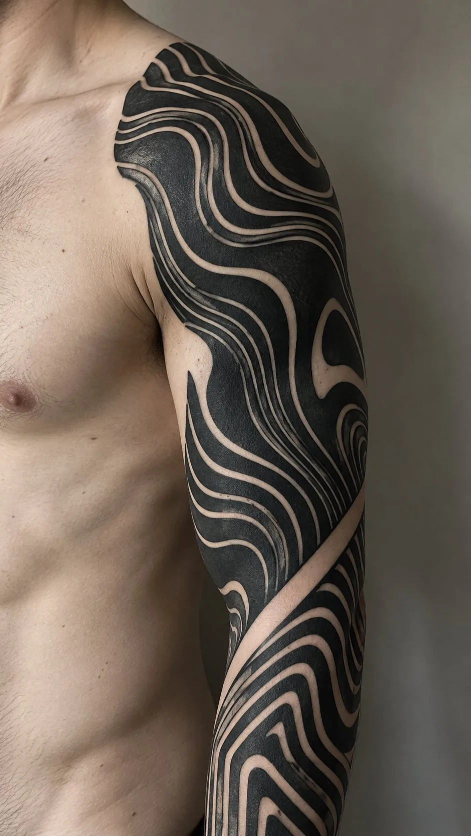 Flowing blackwork wave sleeve tattoo