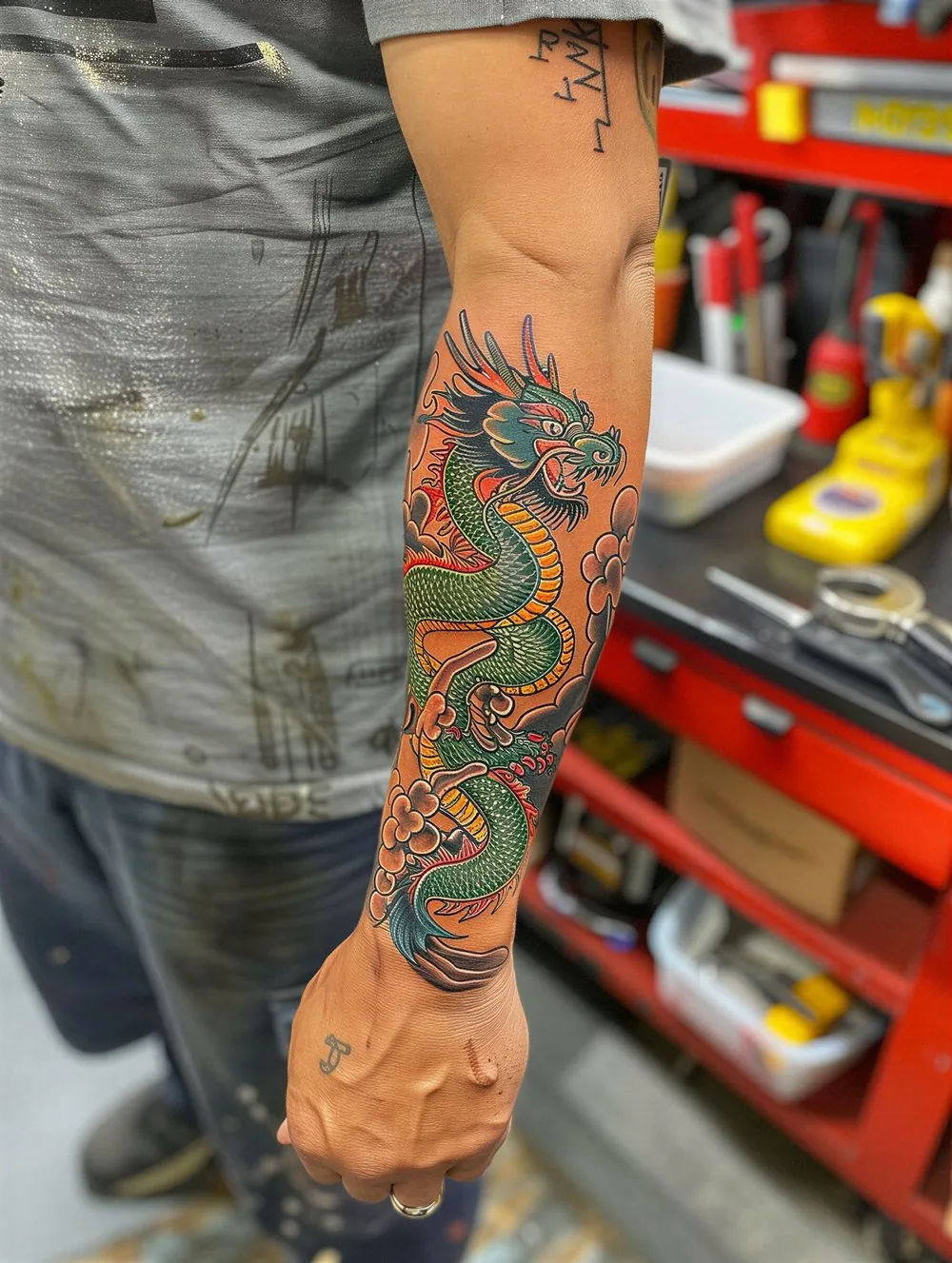 Green Japanese dragon tattoo on the forearm