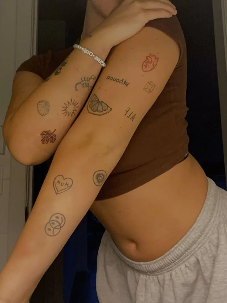 Patchwork of small fine-line tattoos on both arms