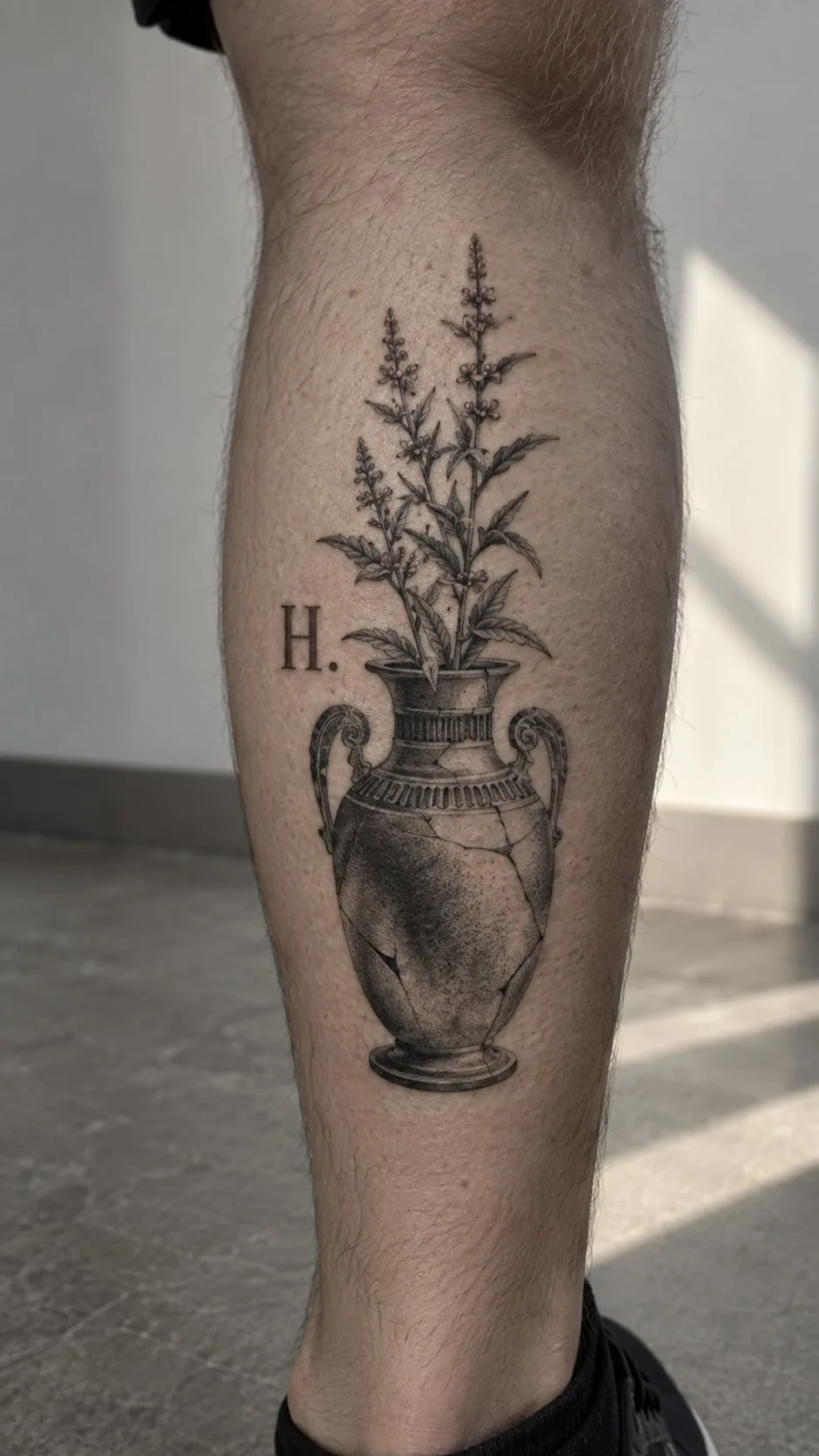 Realistic cracked vase with flowers tattoo on the calf