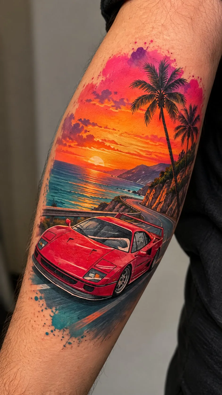Watercolor sports car at sunset tattoo on the forearm